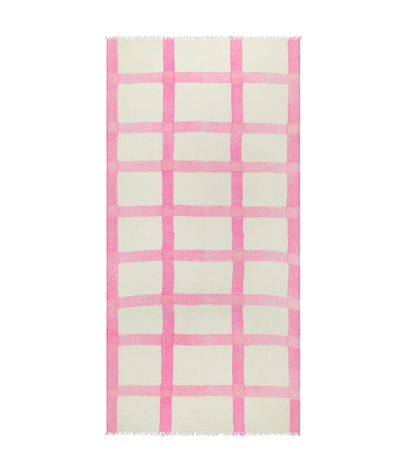 A rectangular cream-colored rug with a pink watercolor-style plaid pattern and fringed edges, shown flat against a white background.