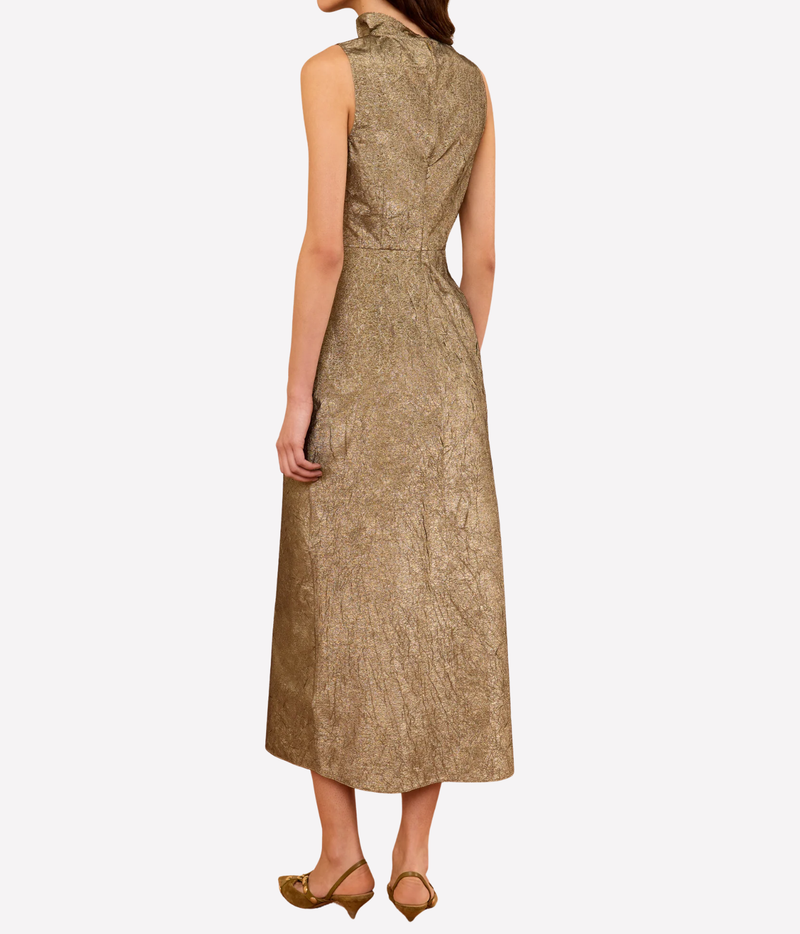 Ulla Johnson Demetria Sleeveless Taffeta Dress in Light Gold, back model view showing the high neckline, fitted upper body and clean full-length skirt.