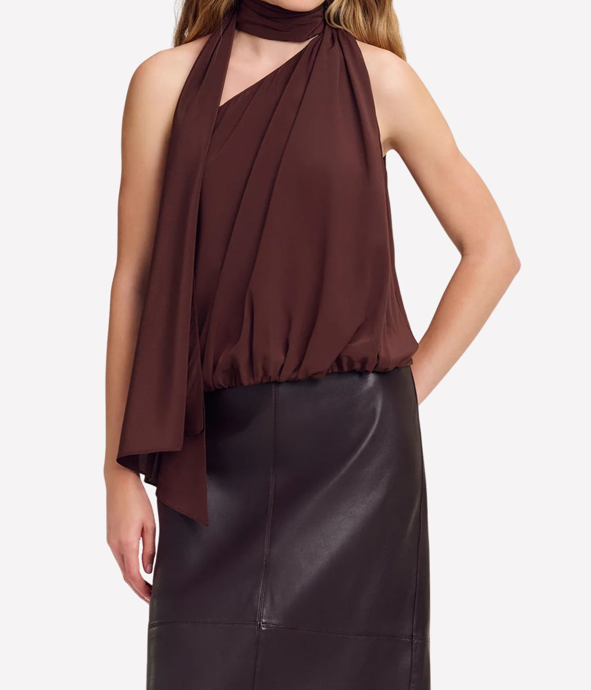 Model wearing the A.L.C. Celeste Top in Coffee with a dark brown leather midi skirt, the long scarf tie draped down the front over the blouson hem