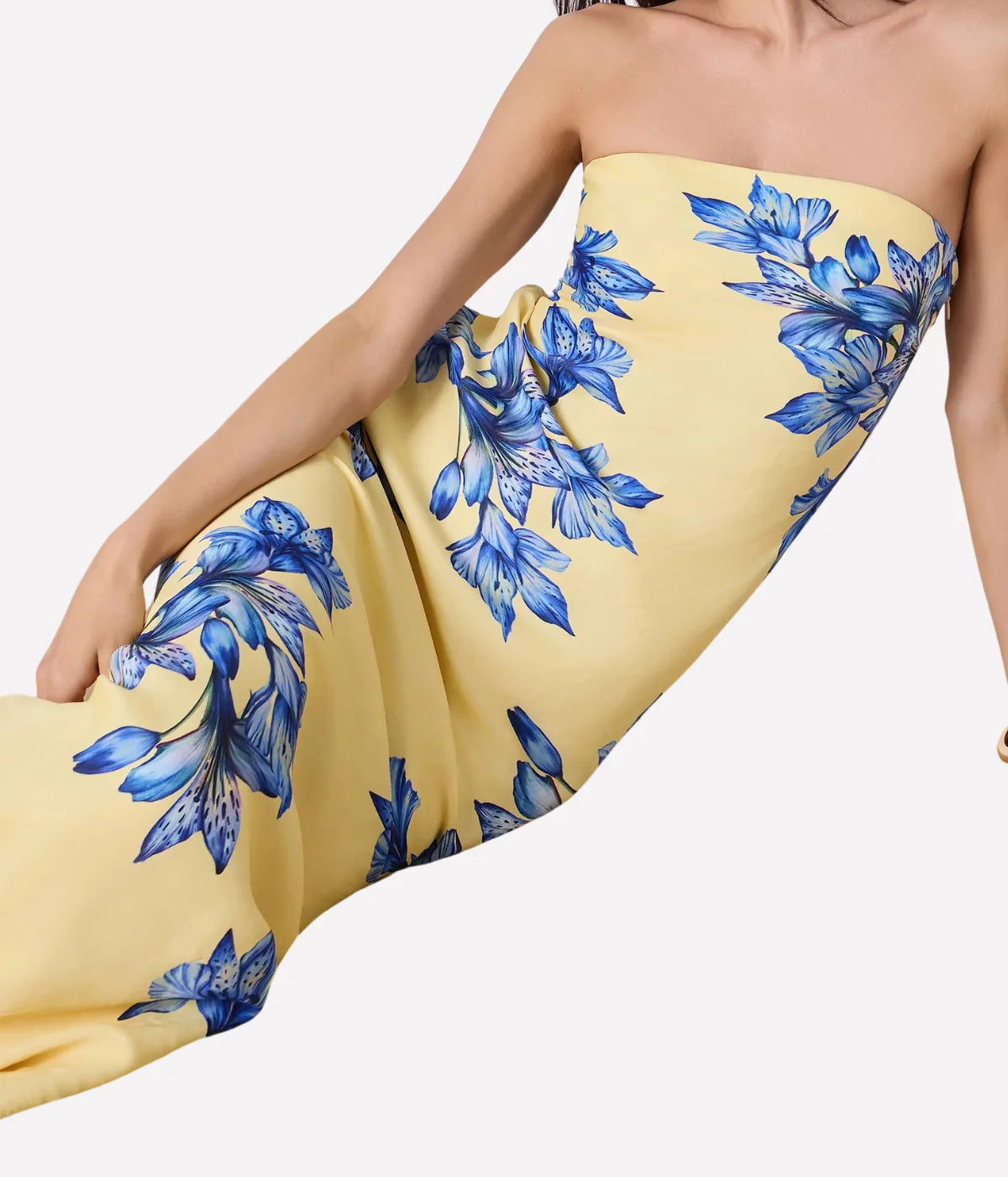 Yellow strapless dress with blue floral pattern on a white background