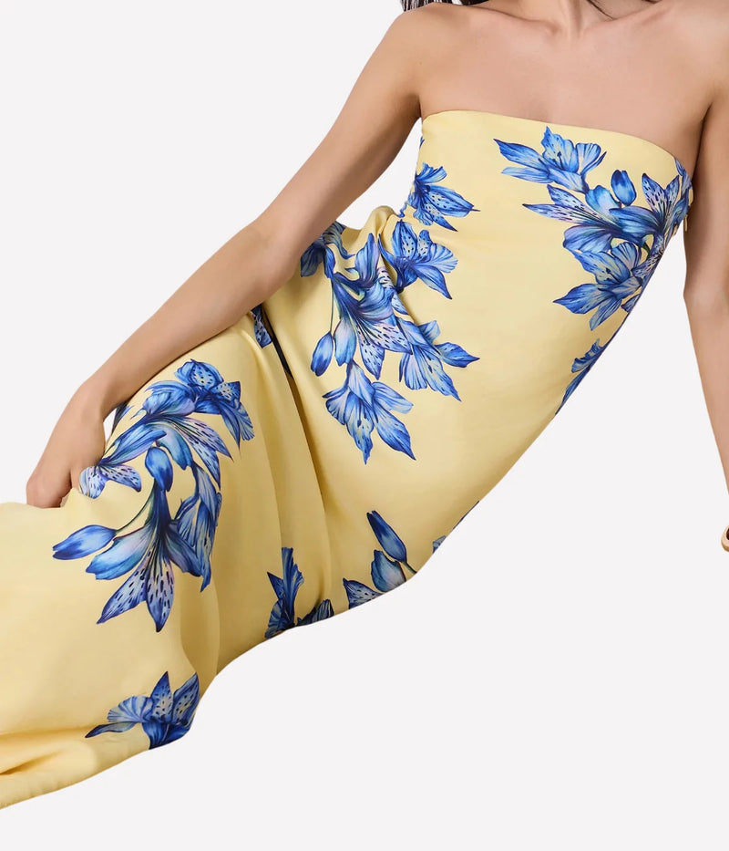 Yellow strapless dress with blue floral pattern on a white background