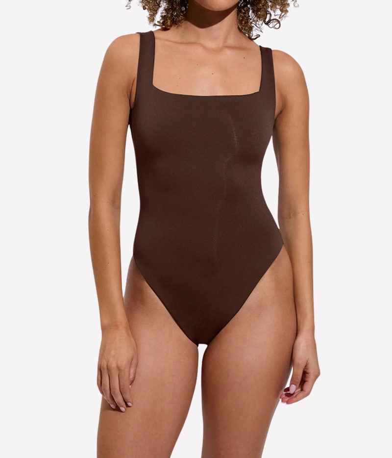 A woman modeling a solid dark brown one-piece swimsuit with a square neckline - Streamline Suit In Cold Brew