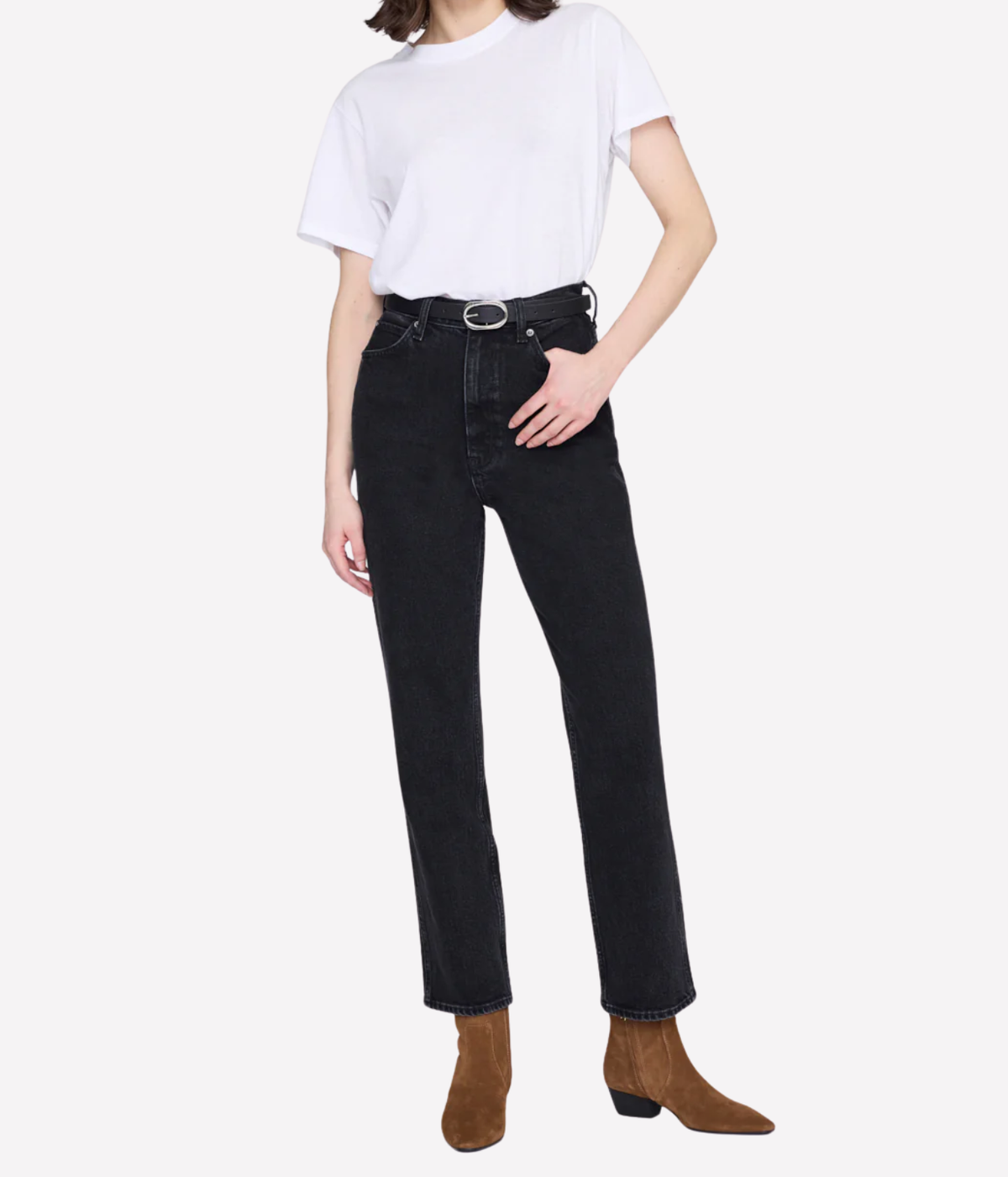 A model wearing black high-waisted straight-leg jeans with a silver-tone belt, styled with a white t-shirt and brown suede ankle boots, against a light gray background.
