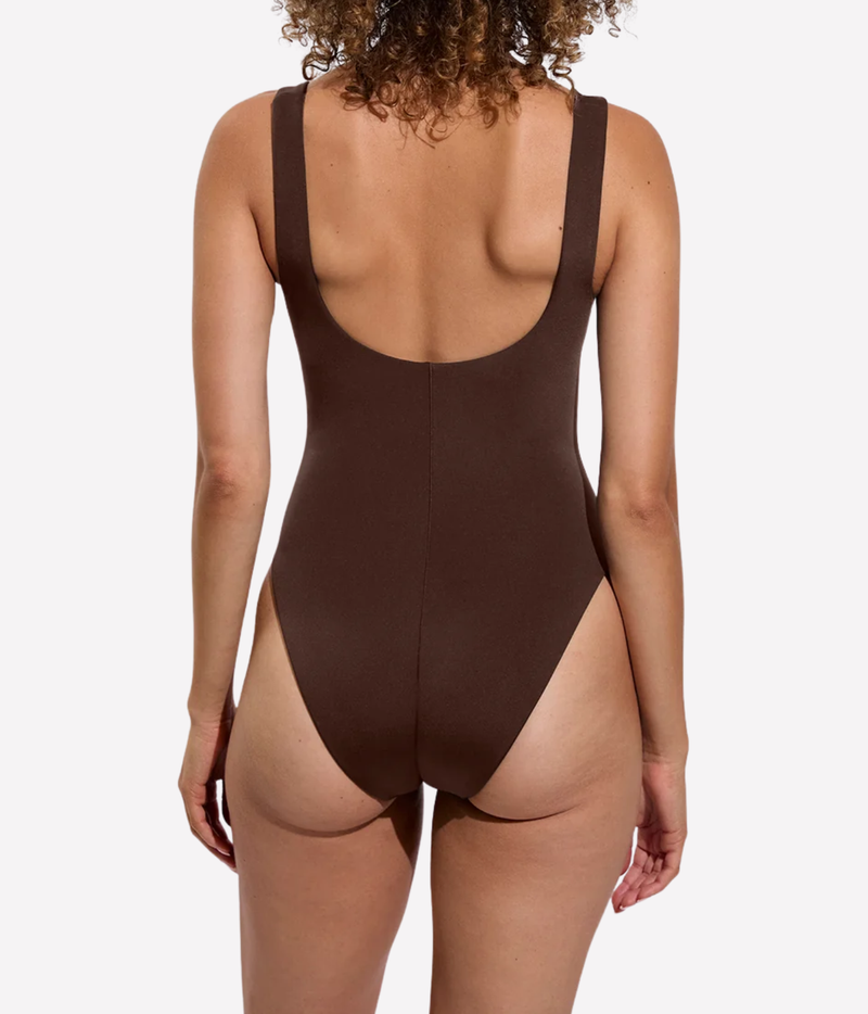 Rear view of a woman wearing a dark brown one-piece swimsuit with a scoop back and wide shoulder straps, Streamline Suit In Cold Brew