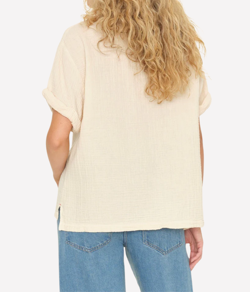 Model shown from back wearing Xirena Avery Top in Oysterette with blue wash jeans 