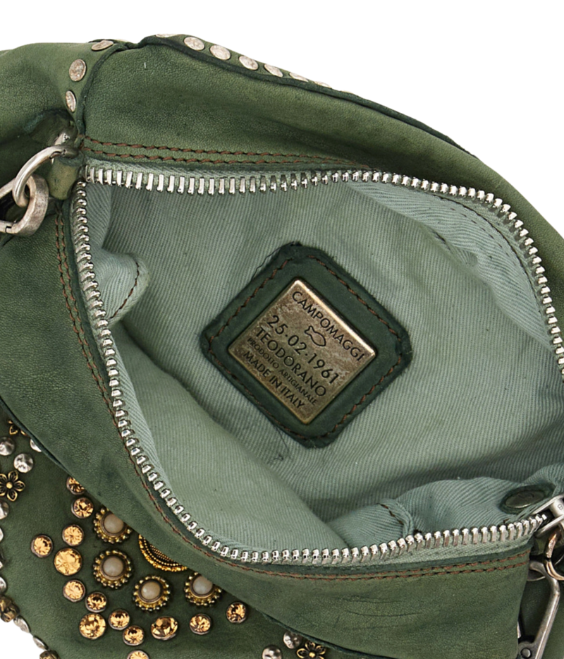 Close-up of the interior of an olive green suede handbag with silver zippers, metal studs, and a central leather patch reading CAMPOMACCHI 1941.