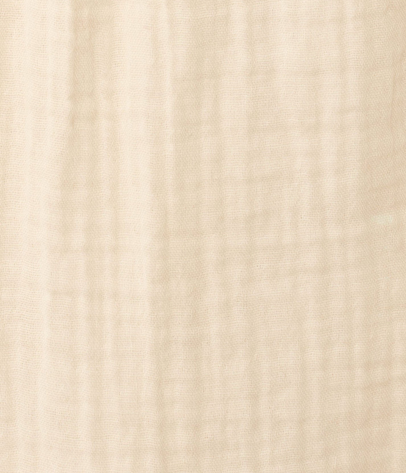 Beige fabric texture swatch of the Xirena Avery Top in Oysterette with blue wash jeans 