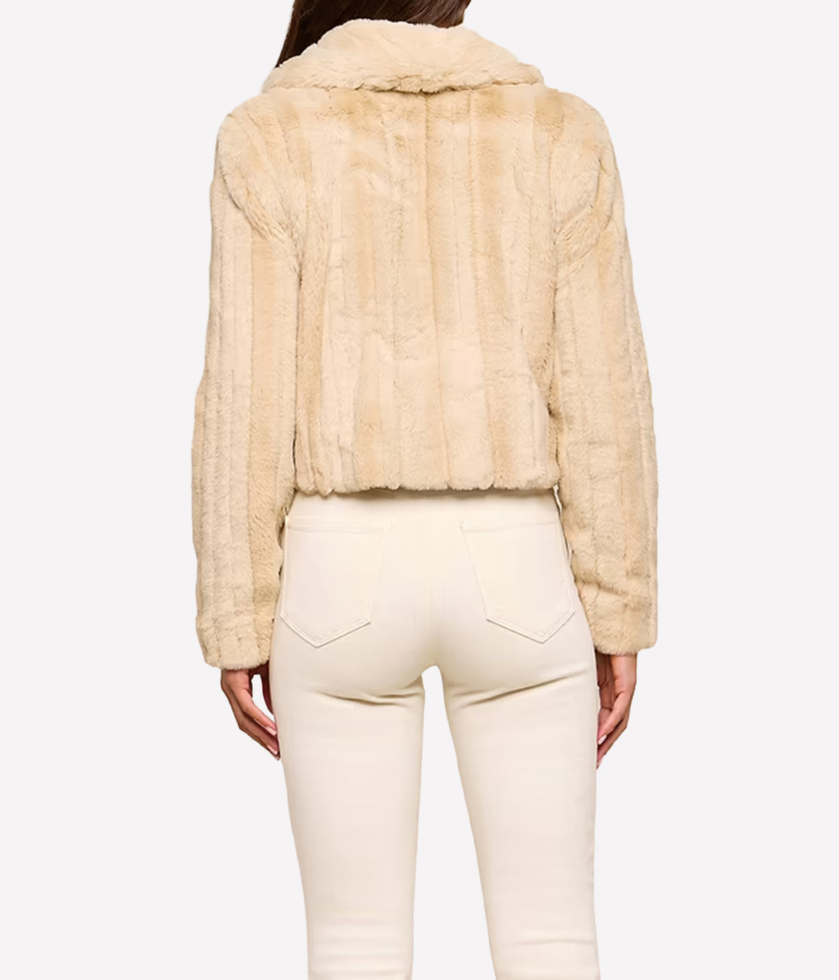 A person shown from the back wearing the L'AGENCE Davy Faux Fur Jacket in Latte Striped Furr, paired with cream-coloured pants, against a plain white background.