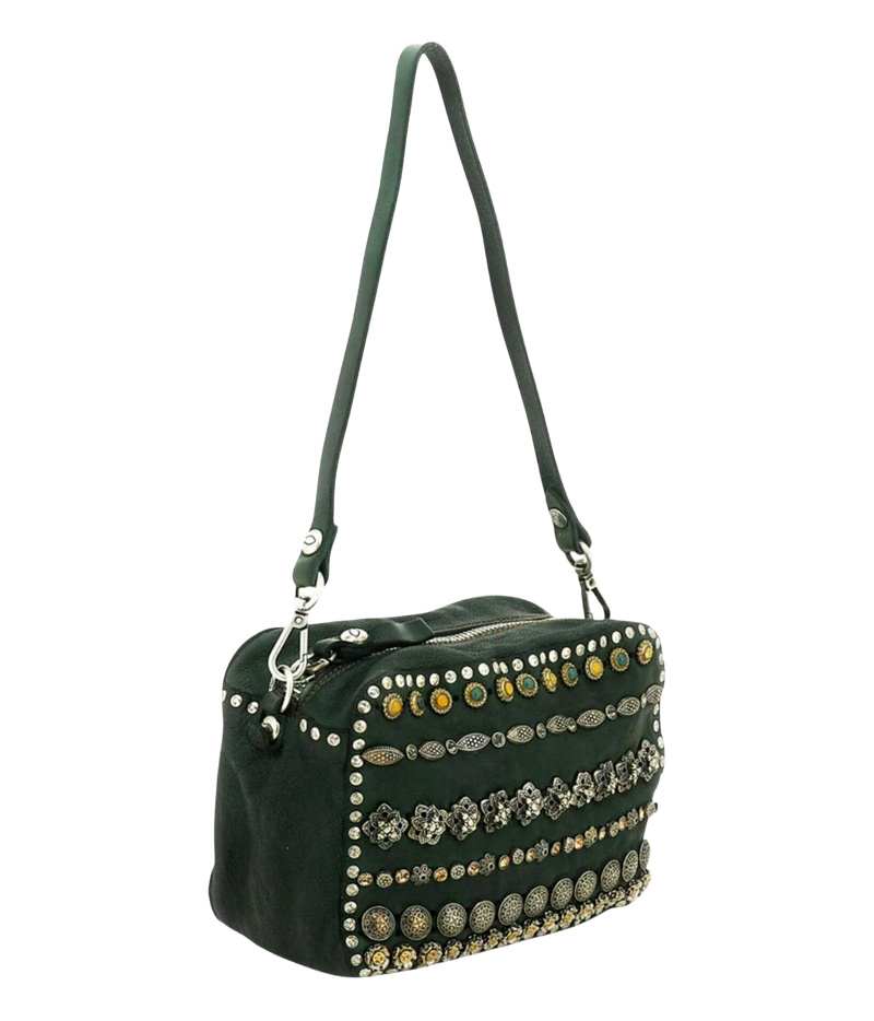A dark green suede shoulder bag with a long strap, decorated with rows of silver and gold-tone studs and metallic coin embellishments on the front flap, shown against a plain white background.