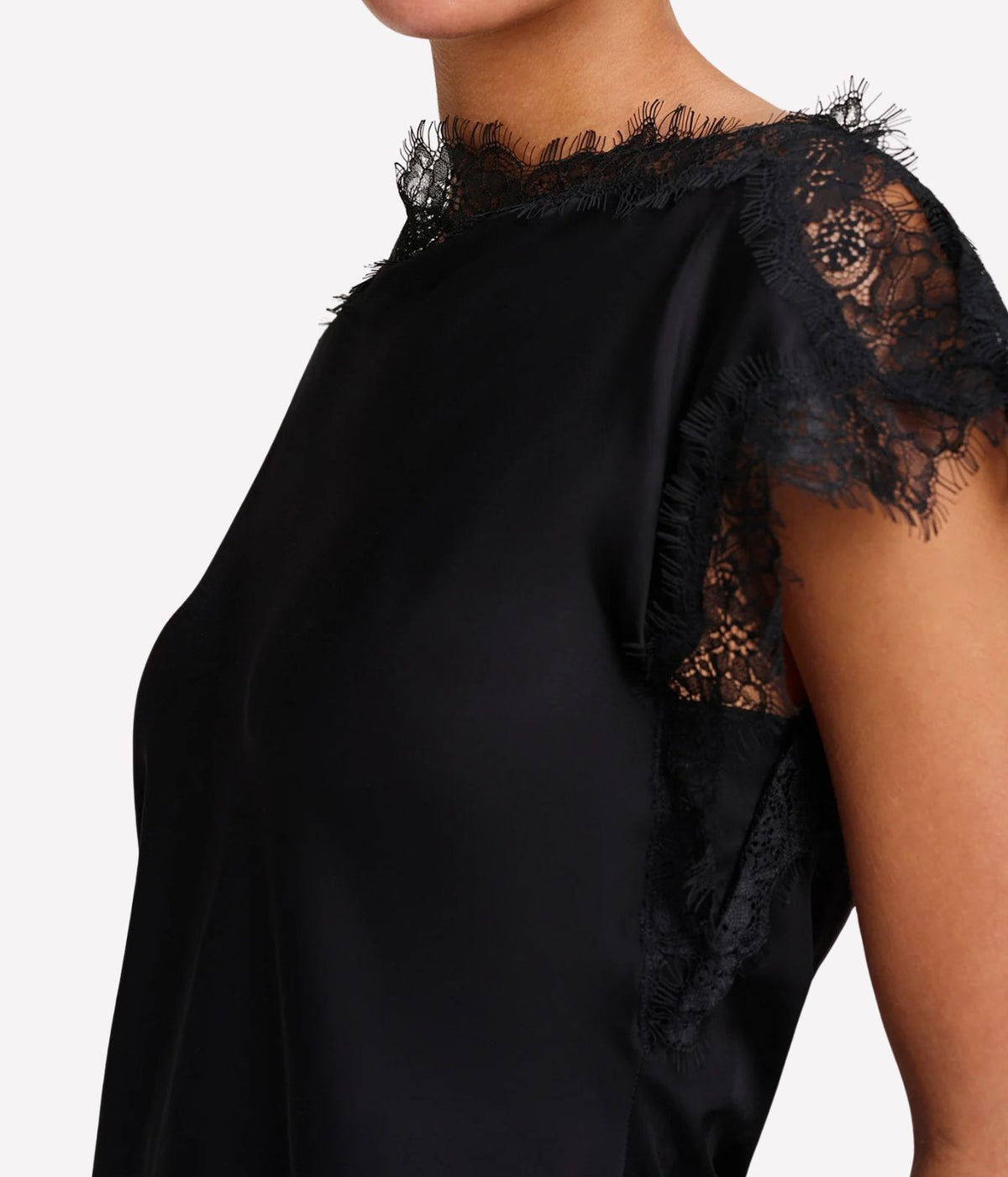 Close-up side view of the A.L.C. Luna Top in Black showing the sheer eyelash lace flutter sleeve and scalloped lace trim along the neckline