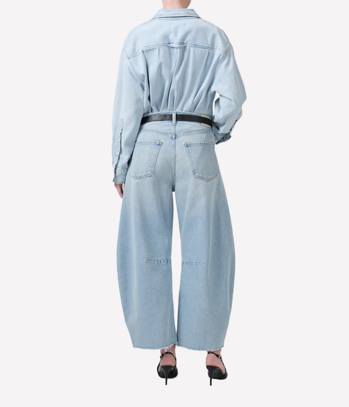 ALT Text: Light indigo cropped jeans with a curved wide-leg silhouette and frayed hems.