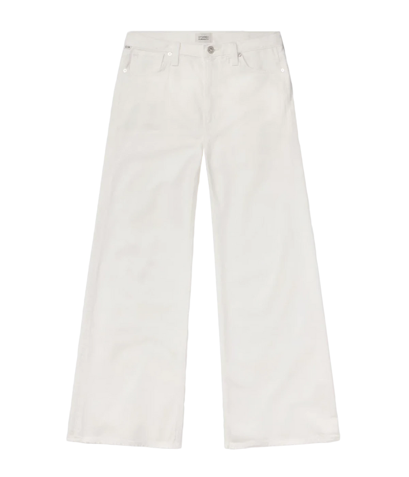 ALT text: Relaxed, high-waisted white pants with vintage detailing, styled with a breezy blouse and slim tank.
