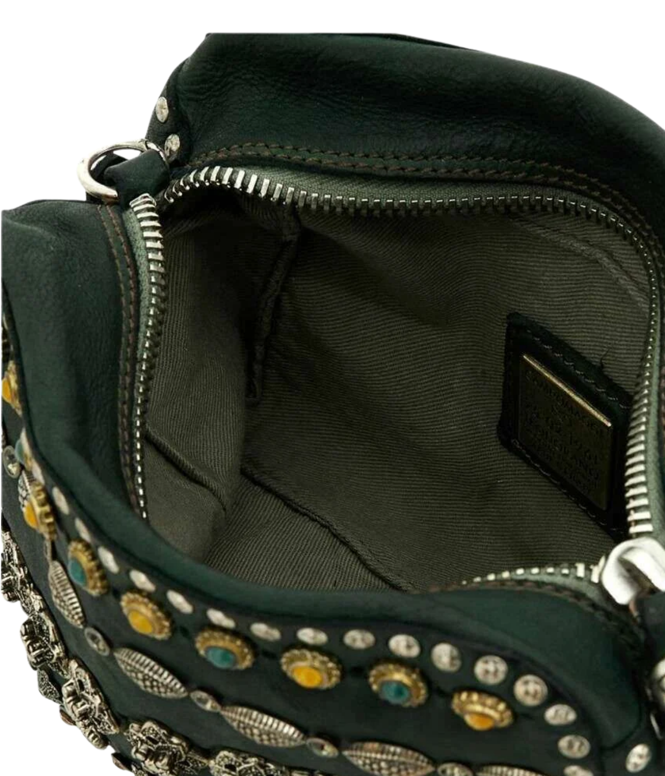 Close-up of the interior of a dark green leather handbag with silver-tone zippers, metal studs, and decorative embellishments. A small interior label is visible.