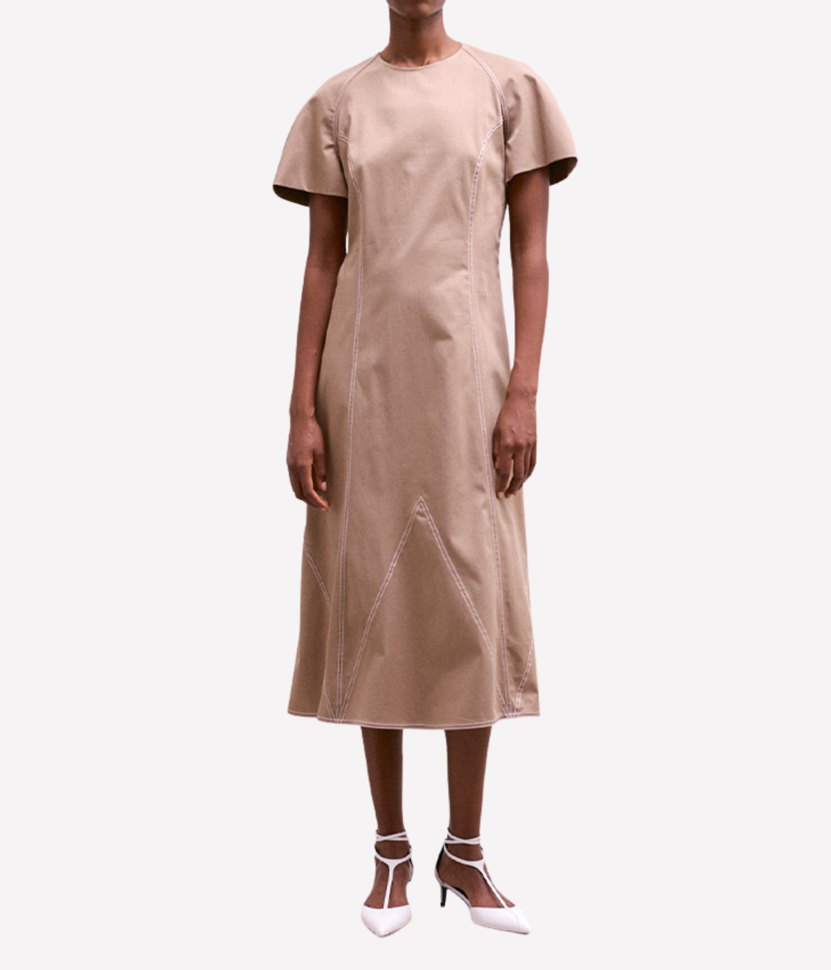 Beige dress worn by a model on a white background