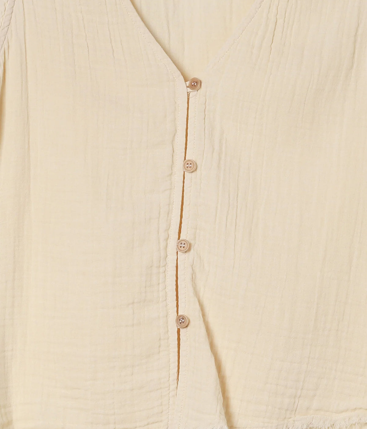 Close-up of the Xirena Naomie Top in Oysterette showing the button front, contrast placket edging and textured cotton