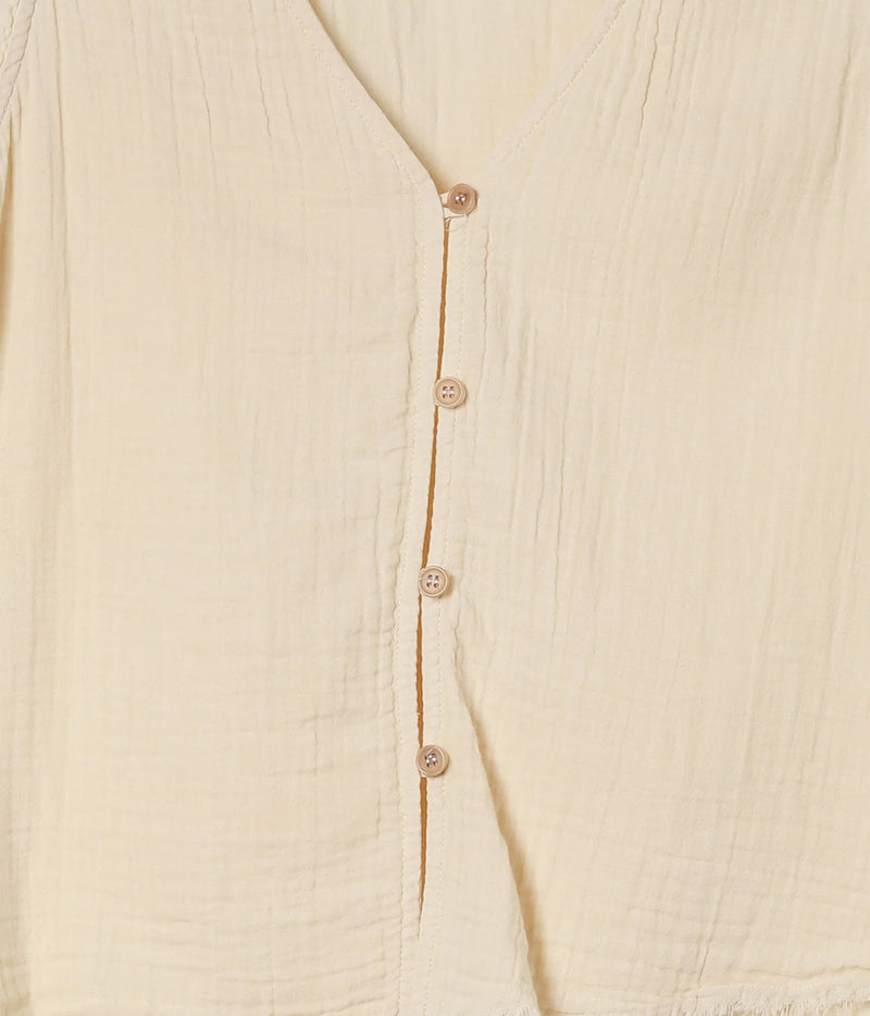 Close-up of the Xirena Naomie Top in Oysterette showing the button front, contrast placket edging and textured cotton
