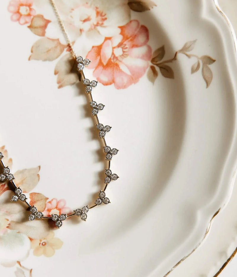 Dana Rebecca Designs Ava Bea Interval Trio Tennis Necklace in 14k Yellow Gold arranged in a gentle curve, highlighting the trio diamond clusters and gold links