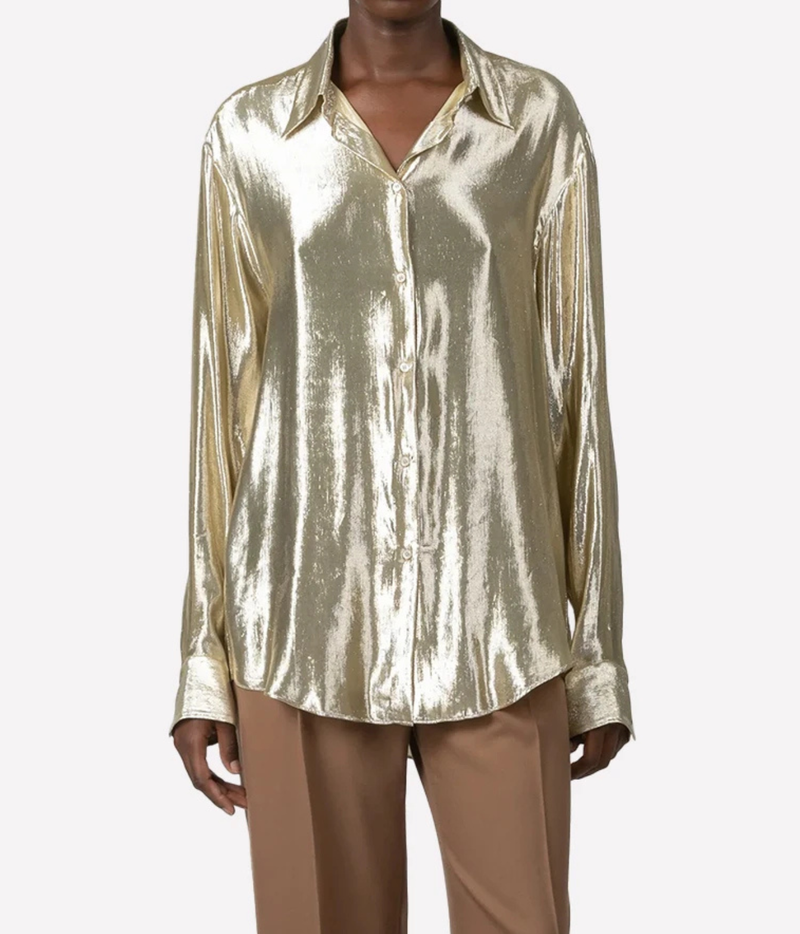 A model wearing a shiny metallic gold button-up shirt 