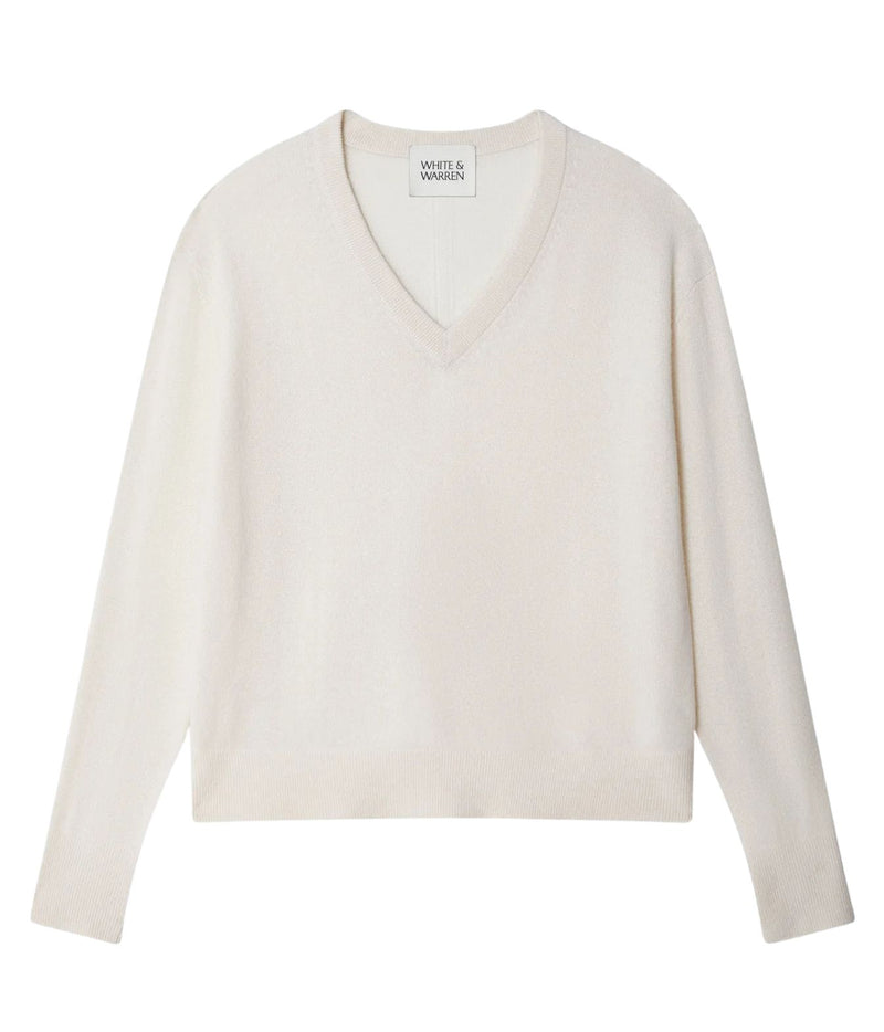 A light cream-colored long-sleeve V-neck knit sweater