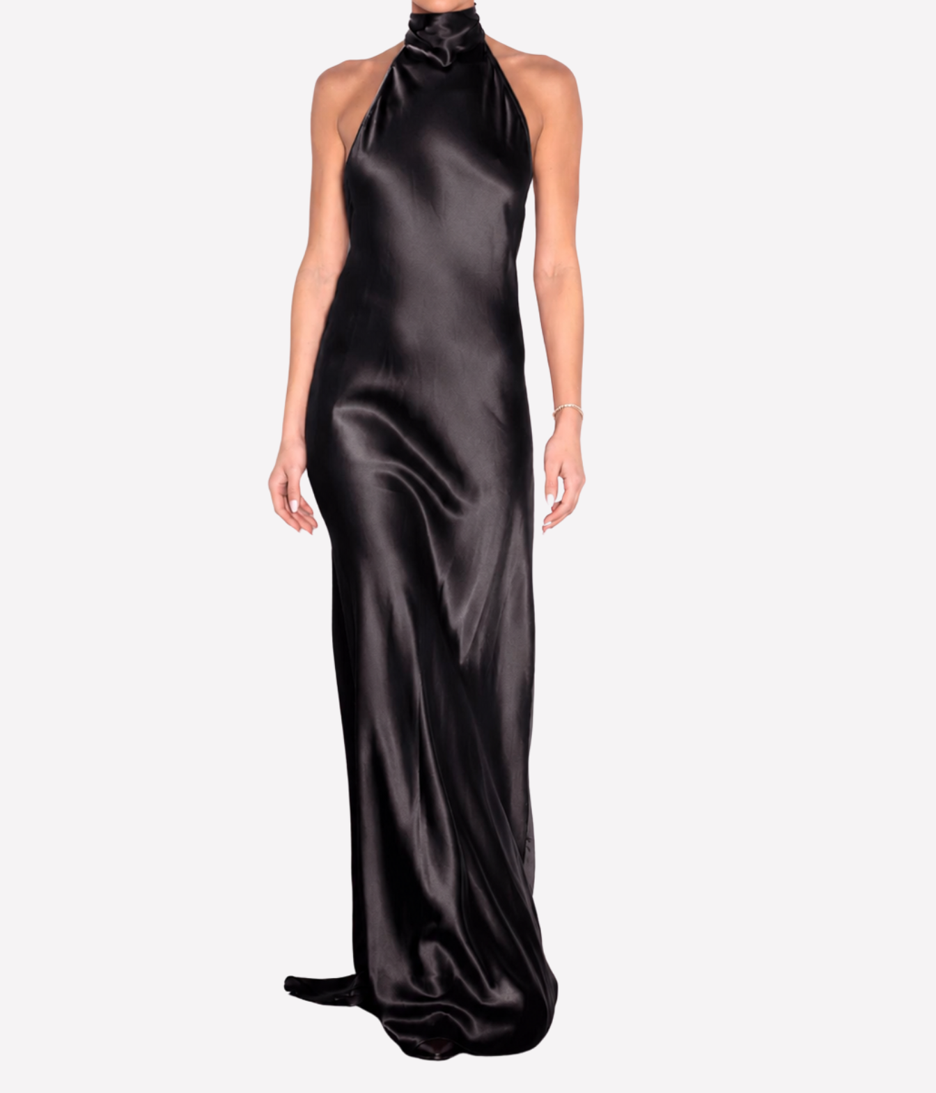 A woman modeling a floor-length black satin halter gown with a high neck and a slight train, shown against a plain light gray studio background.