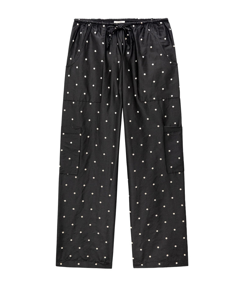 Black cargo pants with a white polka dot pattern, featuring an elastic drawstring waist, side cargo pockets, and a relaxed straight-leg fit, shown flat on a white background.
