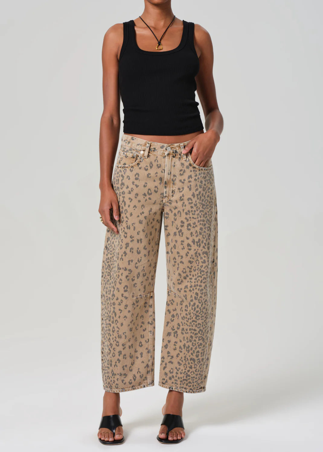 ALT text: Light beige denim jeans with cheetah print, styled with a simple tee.