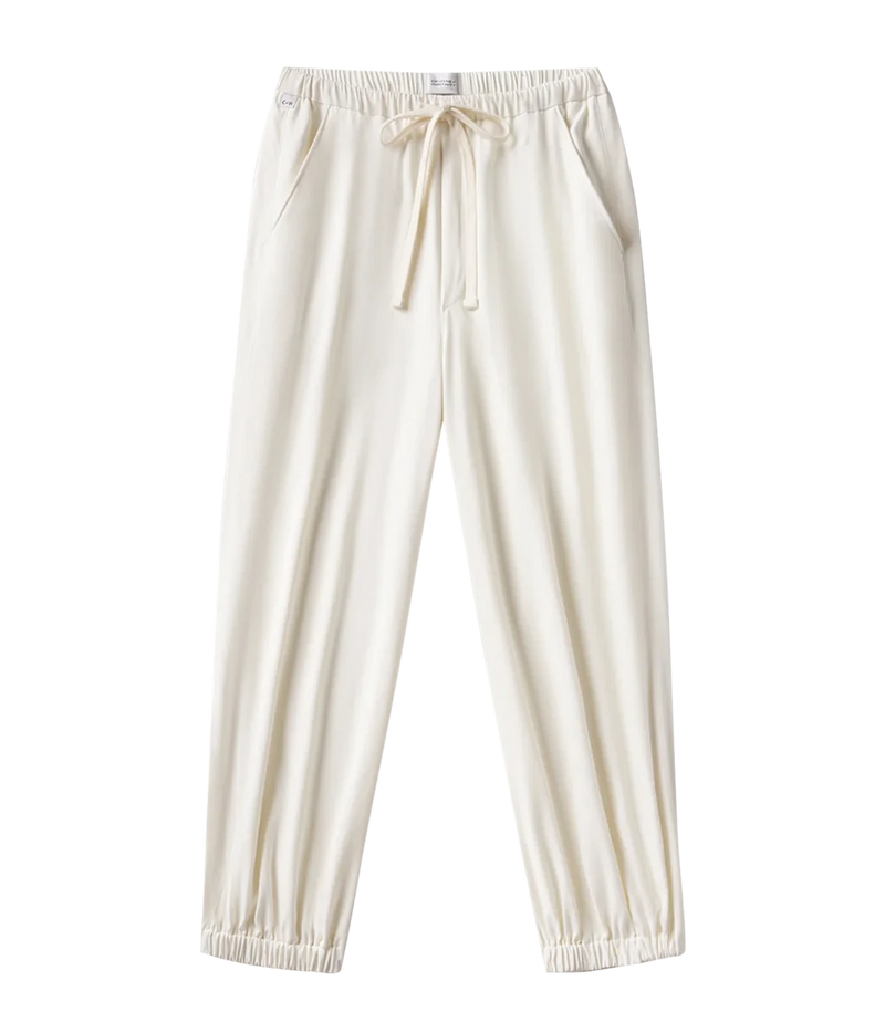 Cream-colored lounge pants with an elastic waistband, drawstring, and elastic cuffs, shown against a plain white background.