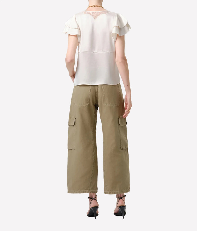 A model shown from the back wearing a cream short-sleeve blouse with ruffled sleeves and a lace neckline, paired with wide-leg olive cargo pants and black high heels, against a light gray background.