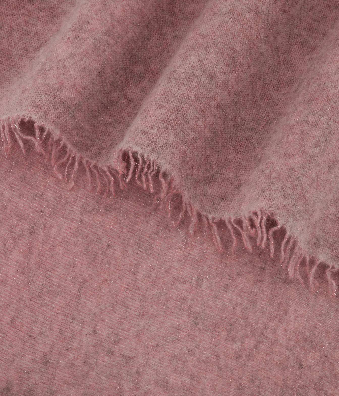 A close-up of a soft woven textile in a dusty rose pink color, draped to show its texture and frayed edge.