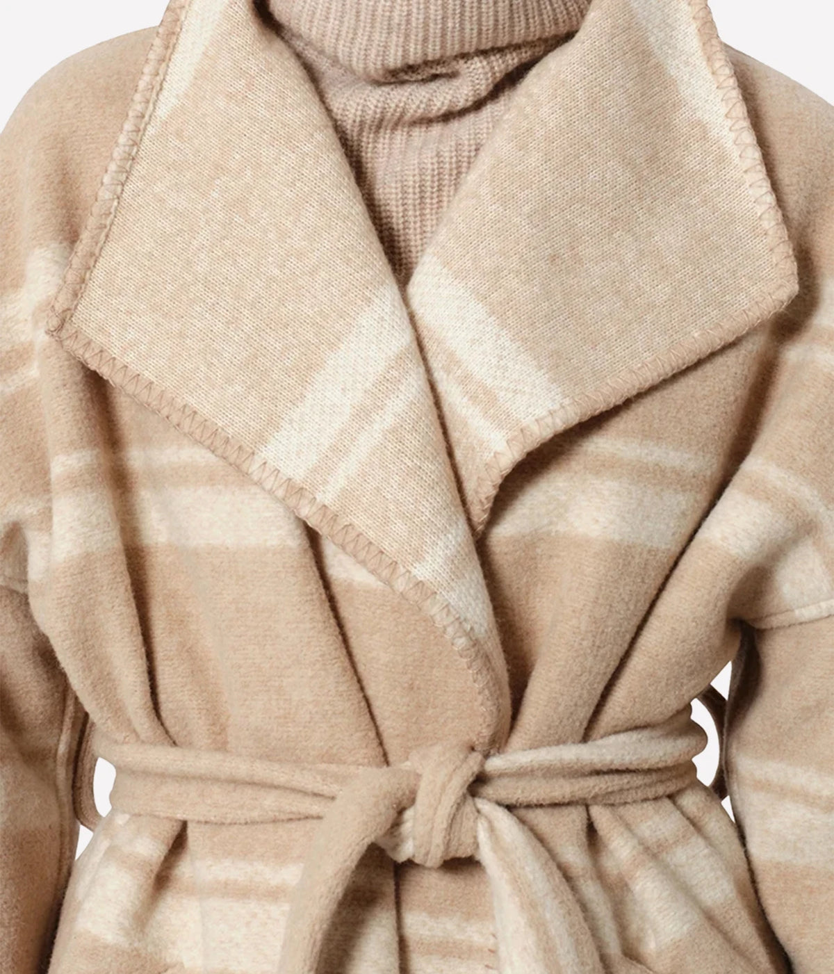 Isabel Marant Brea Belted Checked Coat - Close-up of a beige and cream plaid wool wrap coat with a matching tie belt, layered over a ribbed knit turtleneck sweater.