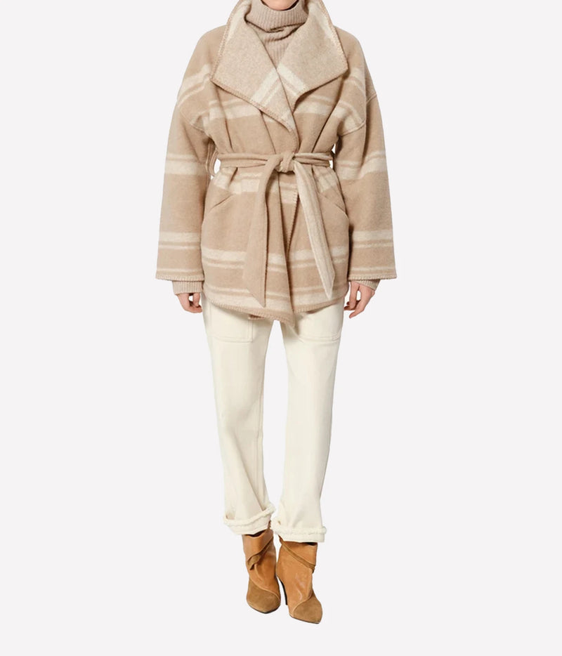 Isabel Marant Brea Belted Checked Coat - A model wearing a beige and cream plaid belted coat, cream trousers, and tan ankle boots.
