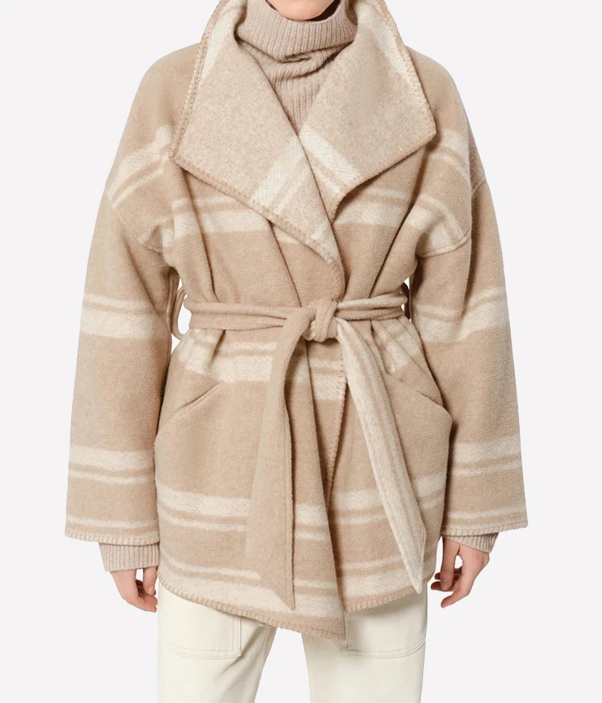 Isabel Marant Brea Belted Checked Coat - A beige and cream plaid wool-blend wrap coat with a matching tie belt, worn by a model over a cream turtleneck sweater and light-coloured pants.