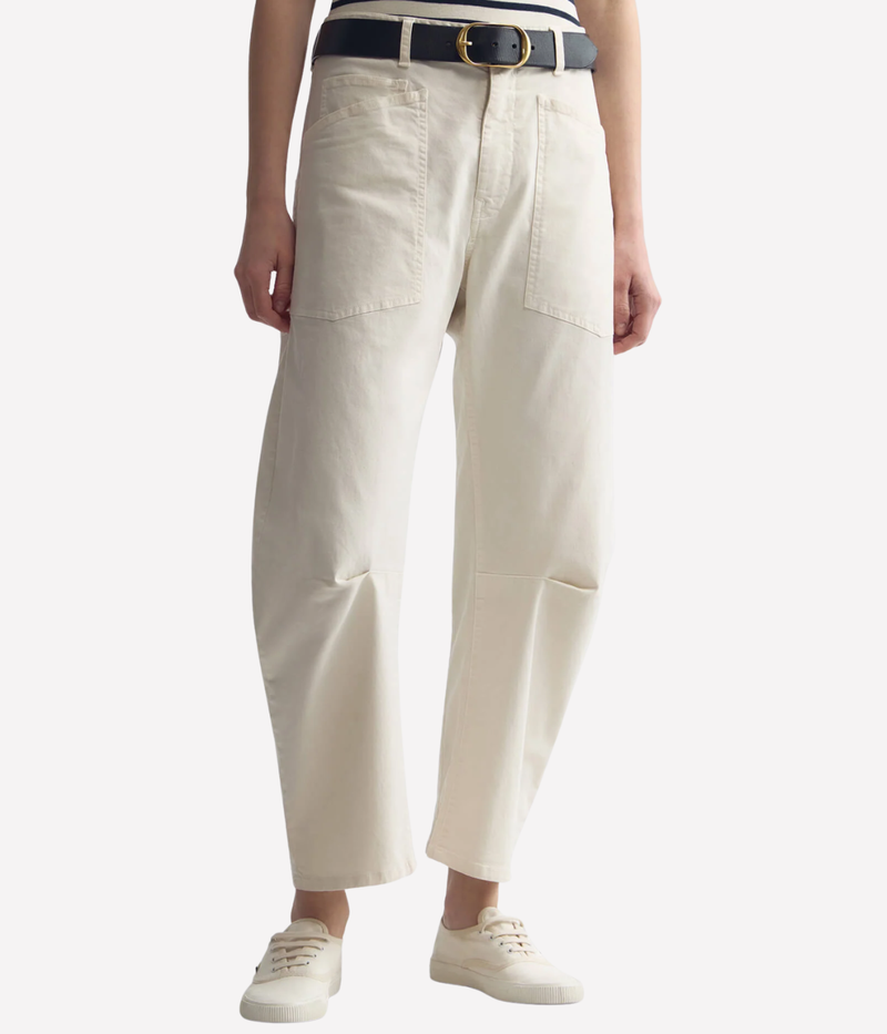 Nili Lotan Shon Pant in Stone, lower half front view on model, showcasing relaxed barrel-leg silhouette with mid-rise fit and tailored seam detailing.