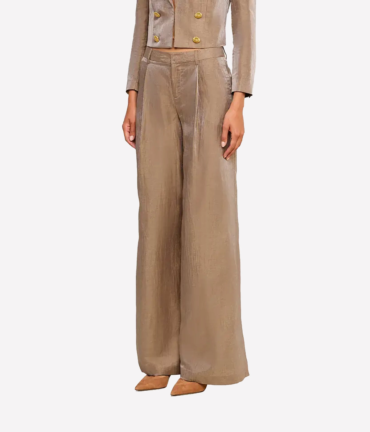 A model wearing a matching beige double-breasted cropped jacket and wide-leg trousers set, paired with tan pointed-toe flats, against a light gray background.