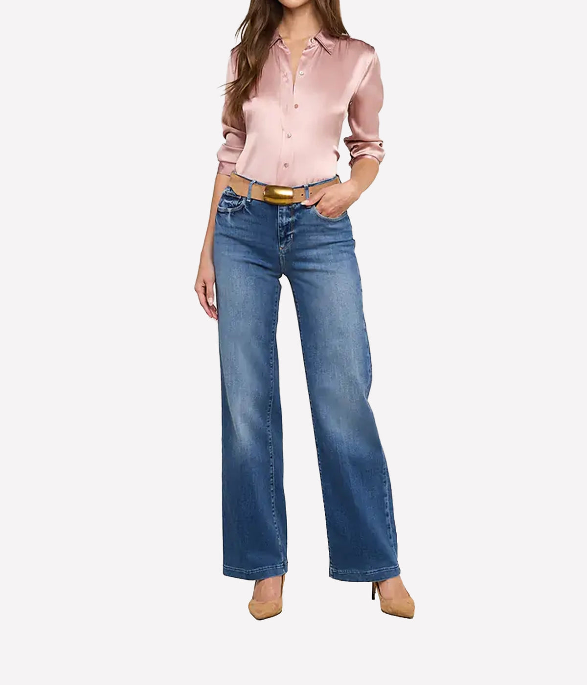A model wearing the L'AGENCE Scottie Wide-Leg Denim Jean in Cambridge, a light pink satin button-up shirt, and a gold belt.