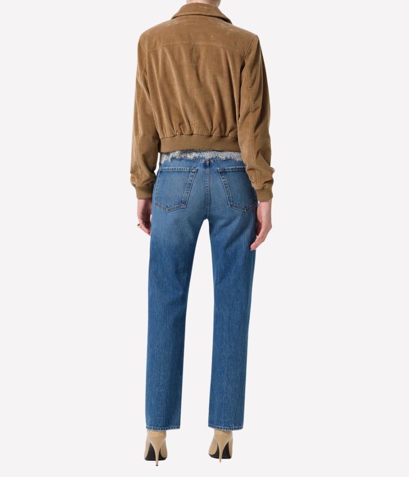Back view of a model wearing the Citizens of Humanity 90s French Straight in Pastis, showing the back pockets and straight leg, styled with a tan cropped jacket and nude heels