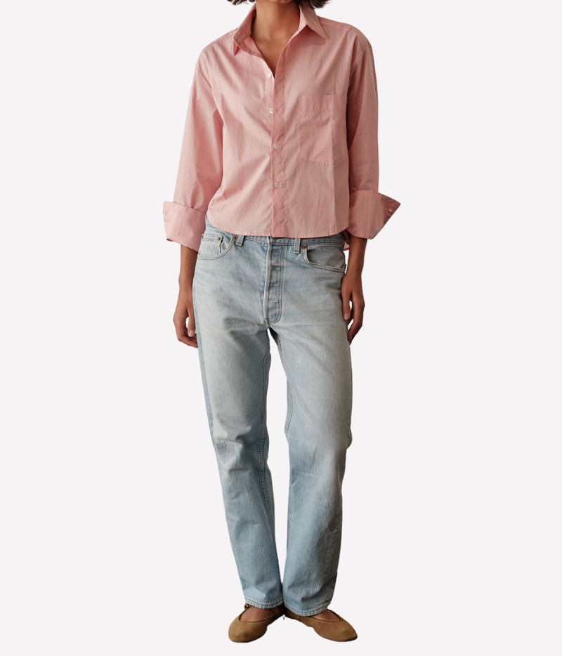 Full-length front view of a model wearing the CISSA Belle Shirt in Blossom untucked with cuffs folded back, styled with light-wash straight-leg jeans and tan flats