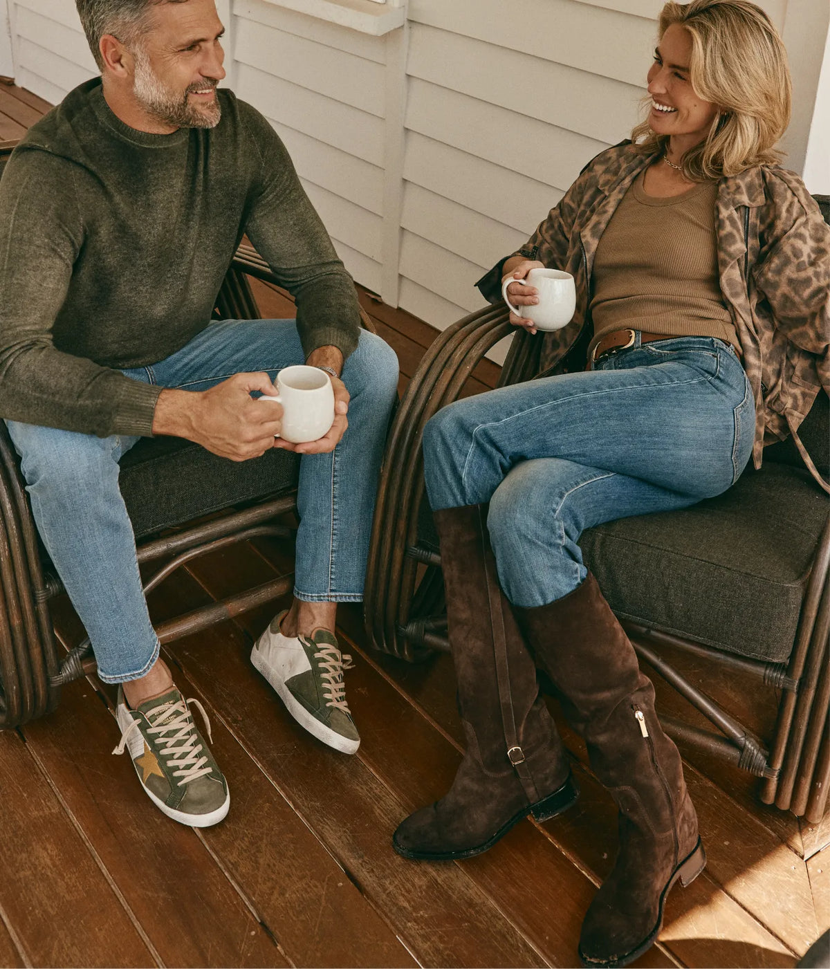 AGOLDE Poppy Tank In Hamoa, worn on model under a leopard print jacket with blue jeans and tall brown boots, seated on a veranda with a coffee