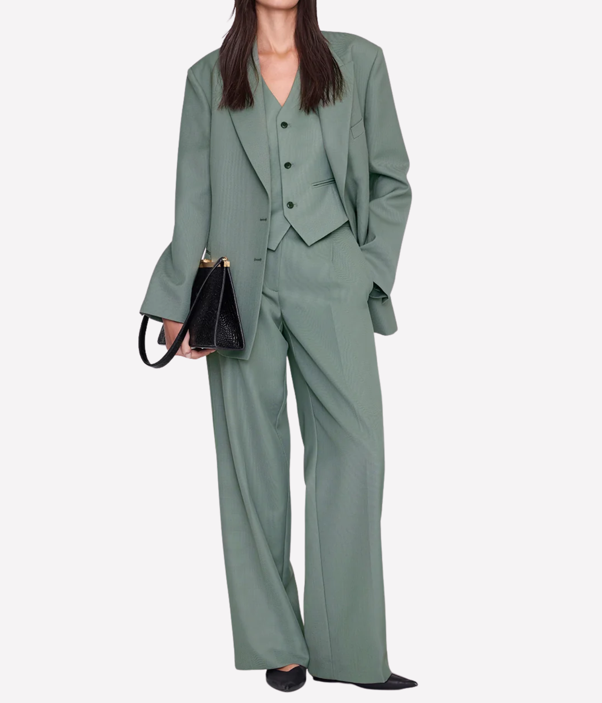 Model wearing the Anine Bing Mario Vest in Sage as a three-piece suit with the matching sage blazer and wide-leg trousers