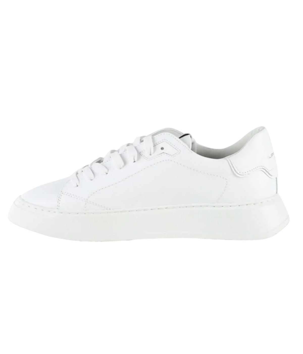 A white leather low-top sneaker with matching white laces and a thick white sole