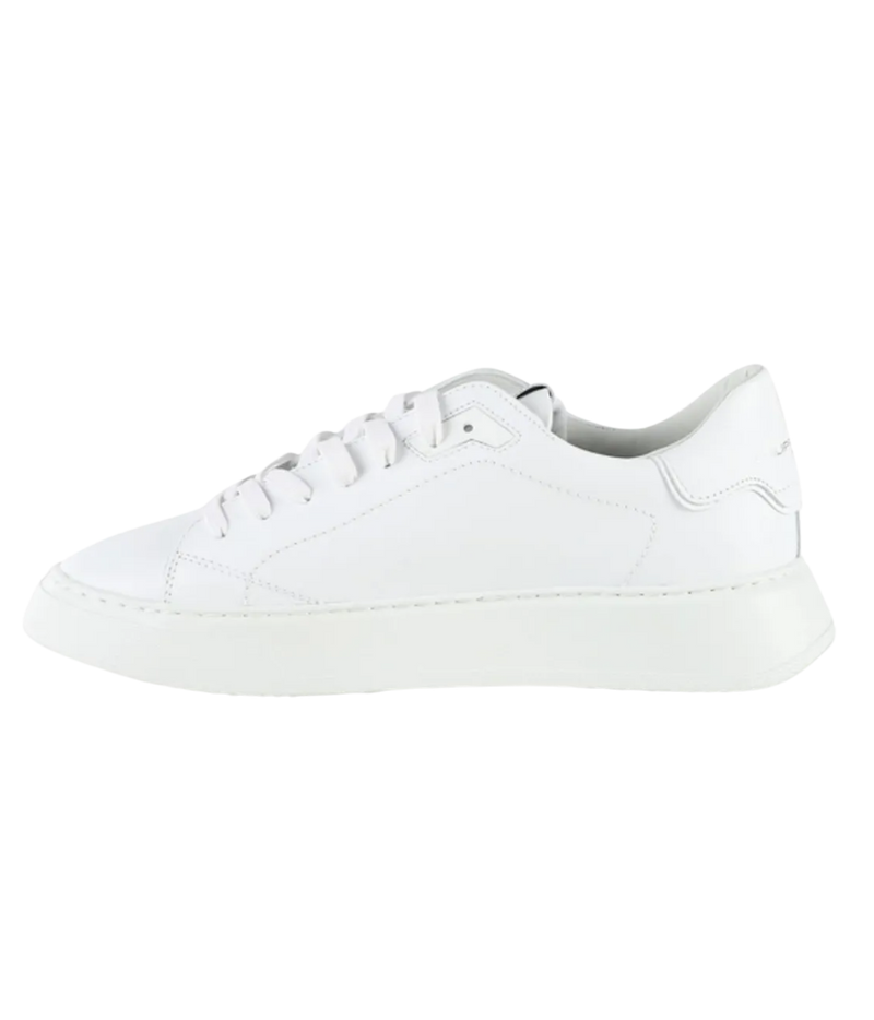 A white leather low-top sneaker with matching white laces and a thick white sole