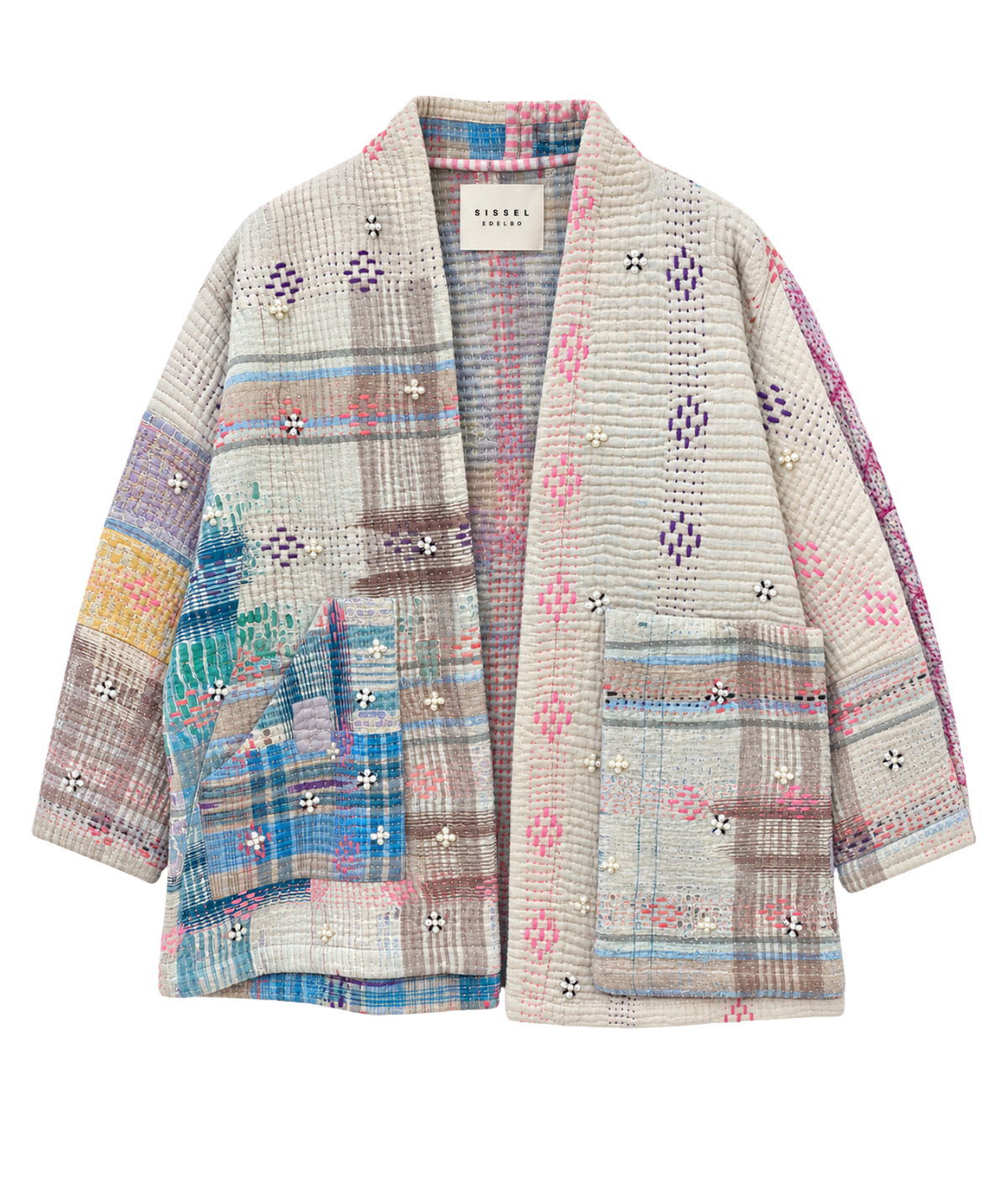A women's open-front quilted cardigan , featuring a multicolor patchwork design with plaid, geometric, and floral motifs on a textured cream base.