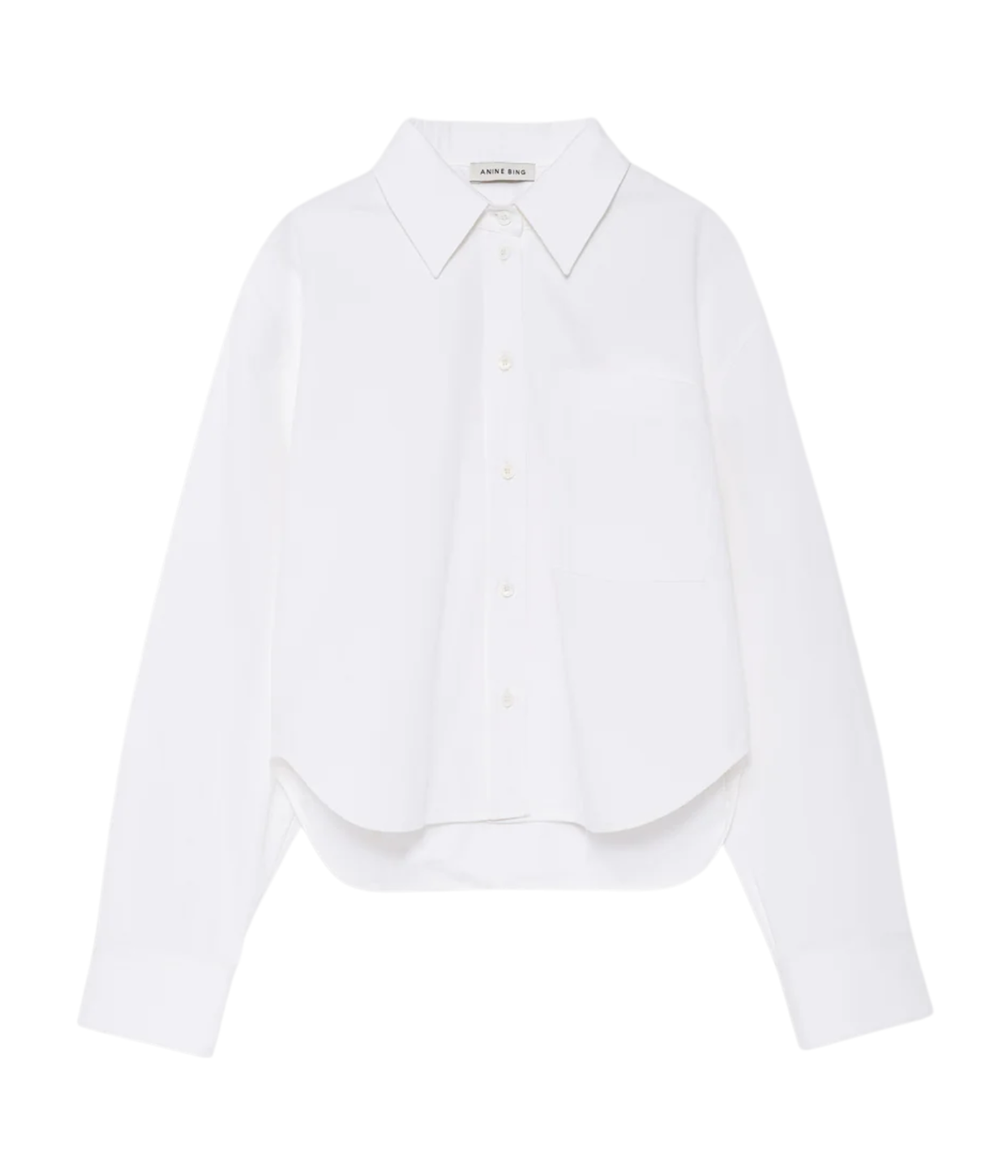 A white long-sleeve button-up shirt with a pointed collar, single chest pocket, and a relaxed cropped silhouette, shown on a plain white background.