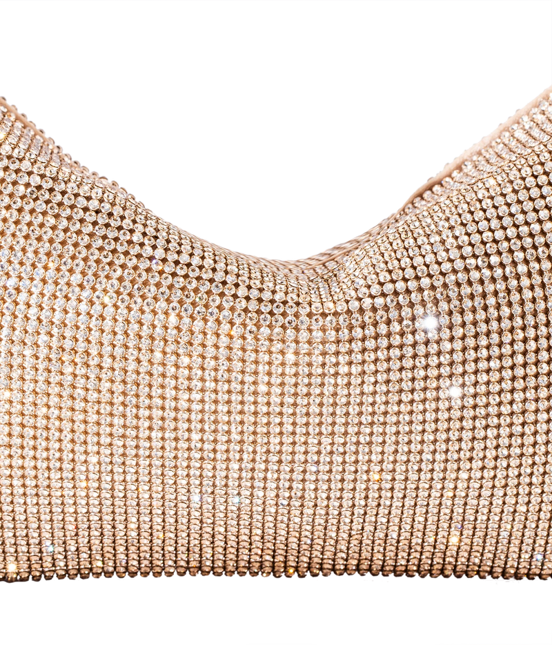 Close-up of a rose gold rhinestone mesh garment, showing the textured, shimmering surface against a plain white background.