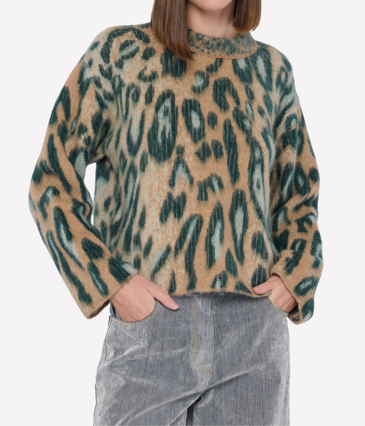 Front view of a model wearing the forte forte Brit Leopard Jacquard Gauzed Alpaca Sweater in Woods with her hands in the pockets of grey corduroy wide-leg trousers