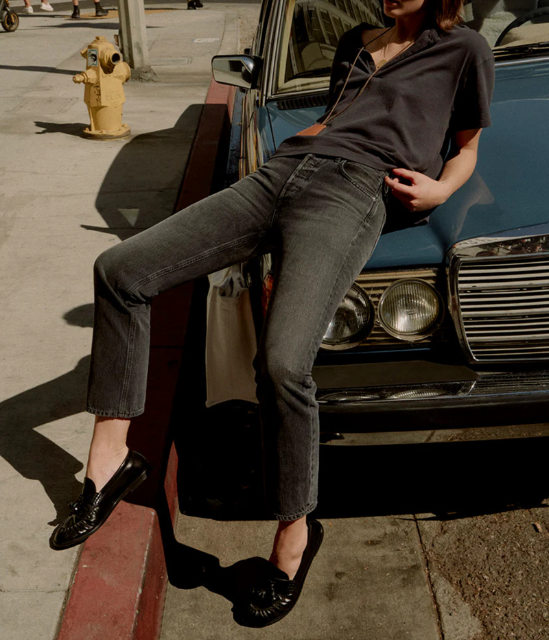 Outdoor lifestyle image of a model wearing the Citizens of Humanity Blaine Jean in Vintage Black showcasing the high-rise fit and straight-leg silhouette.