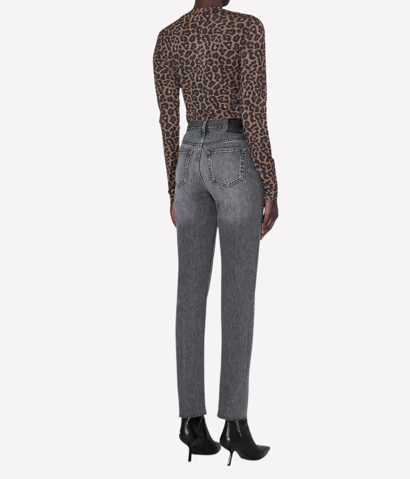 Rear view of a model wearing high-waisted gray jeans, a brown leopard-print long-sleeve top, and black ankle boots against a light gray background.