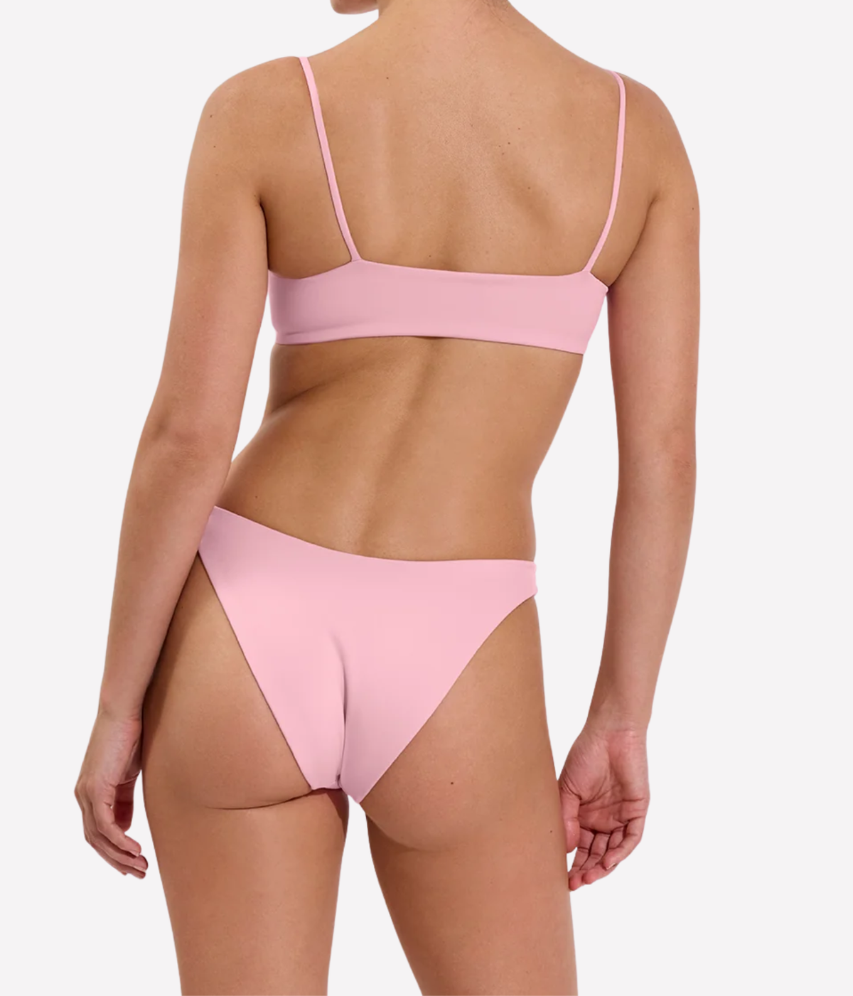 A model shown from the back wearing a light pink two-piece bikini with a bandeau-style top and high-cut bottoms, Left On Friday, Dip Bottom In Delight