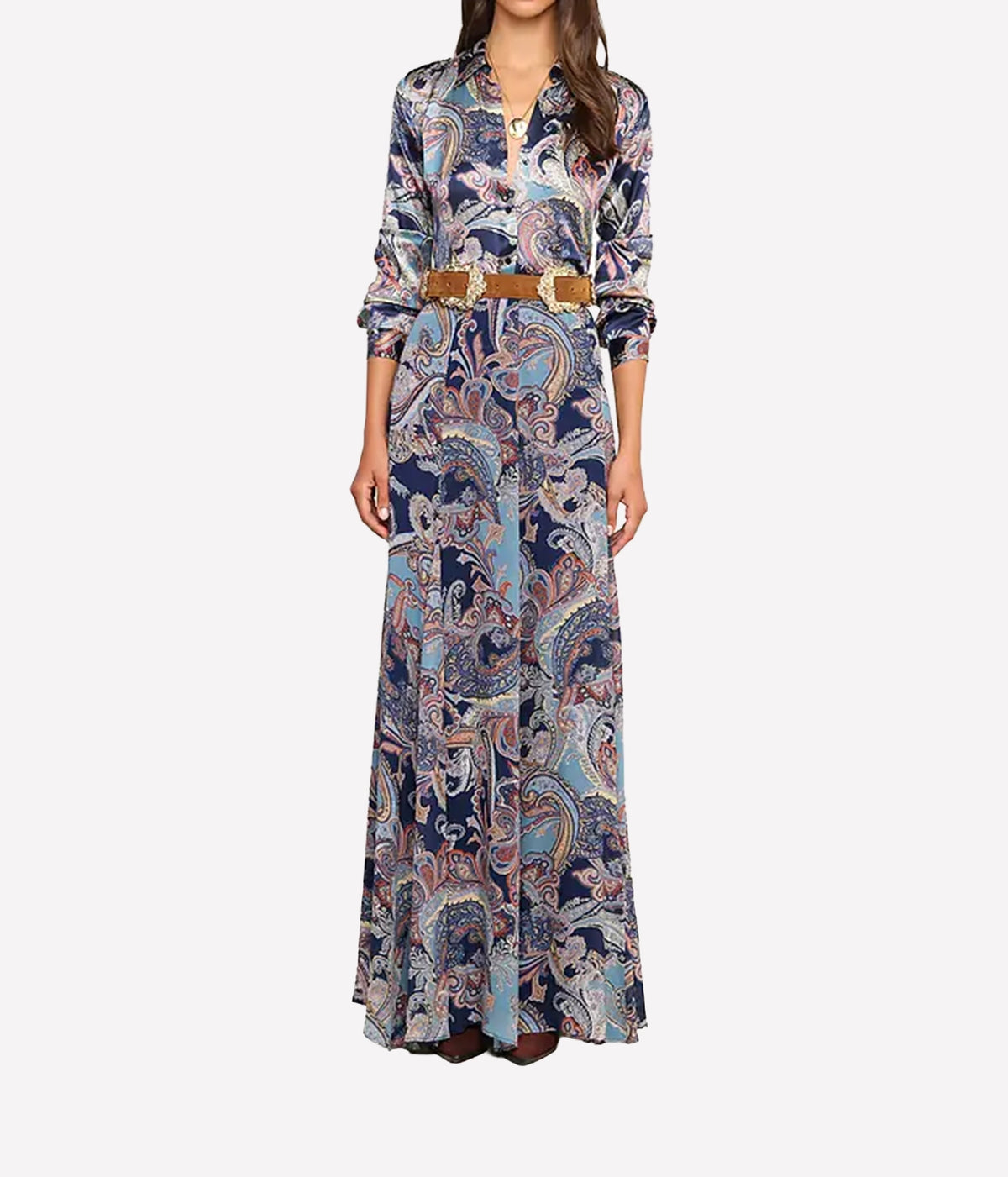 A woman modeling a long-sleeve shirt with a blue, beige, and white paisley pattern, featuring a brown belt at the waist.