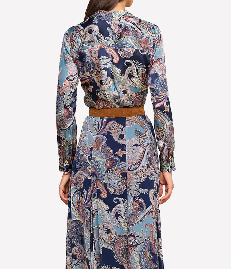 A model shown from the back wearing a long-sleeve shirt with an intricate multicolor paisley pattern in light blue, beige, with a brown belt.